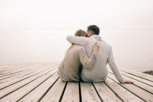 couple hugging on a pier